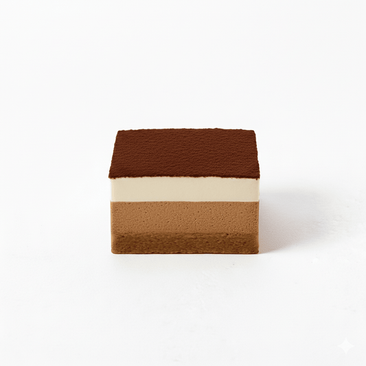 Square slice of Tiramisu with layered textures topped with cocoa powder on a white background