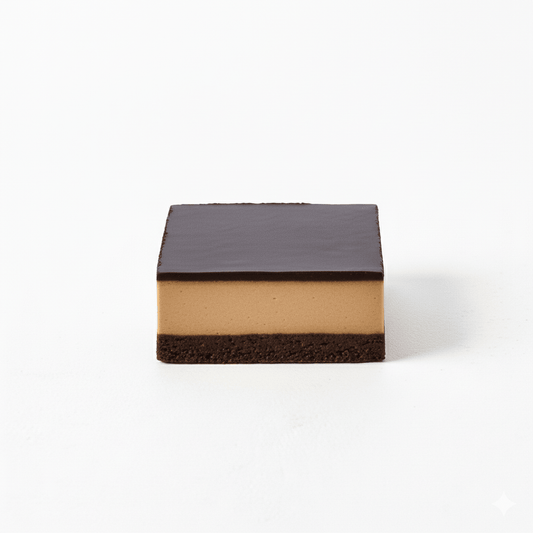 Square layered dessert with dark chocolate top and creamy middle layer named Lucuma on white background