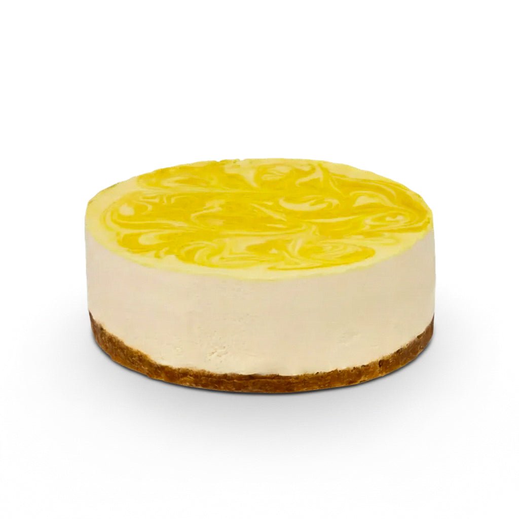 Lemon cake with creamy white filling and yellow swirled topping on a brown crust base isolated on white background