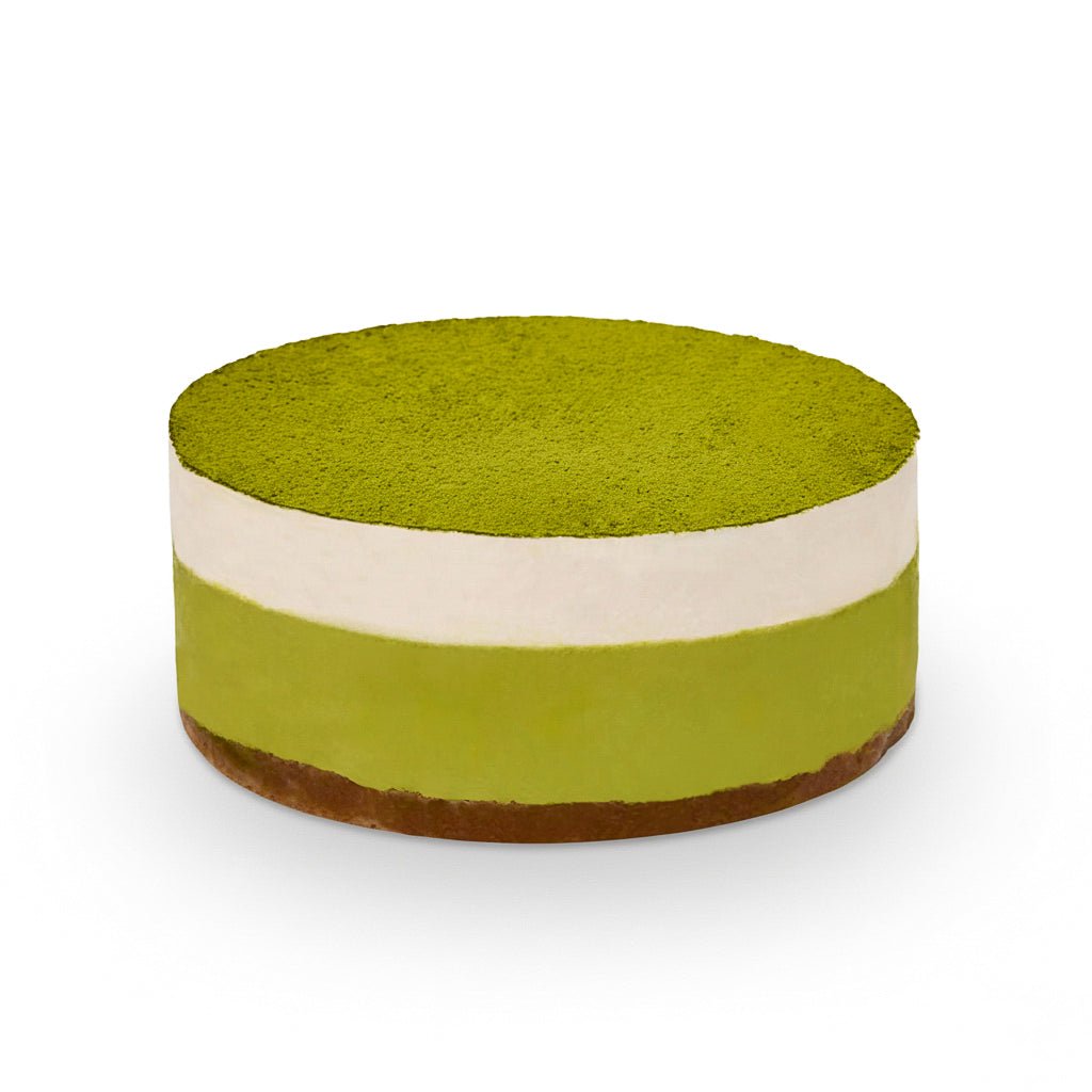 Round layered dessert with green matcha and white cream topped with matcha powder called Matcha Yuzu