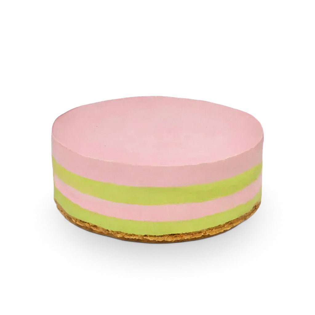 Strawberry Basil raw vegan cake with layered pink and green filling on a golden crust, smooth and elegant design