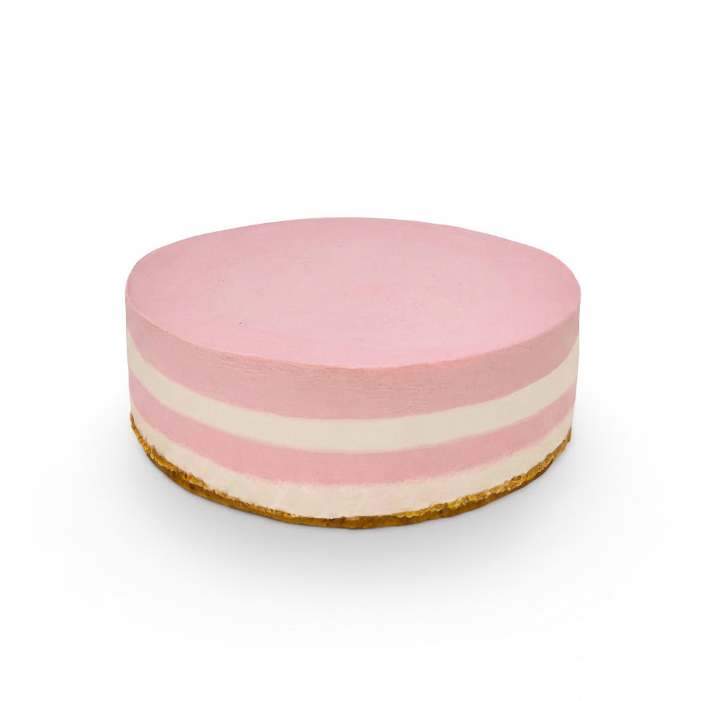 Round layered cake with pink and white stripes on a crust base called Strawberry Cream, simple and smooth finish