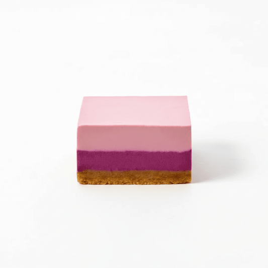 Berry dessert with layered pink and purple filling on a crumbly golden crust square piece